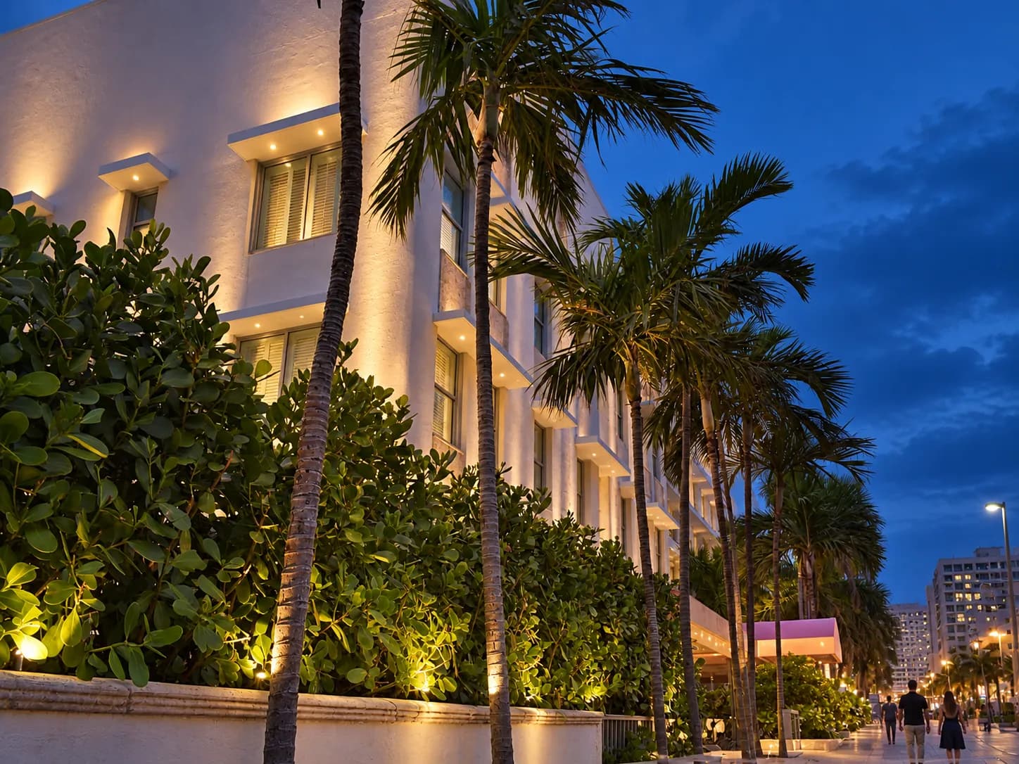 Contemporary district plaza after sunset with geometric facades and uplighting washing the walls
