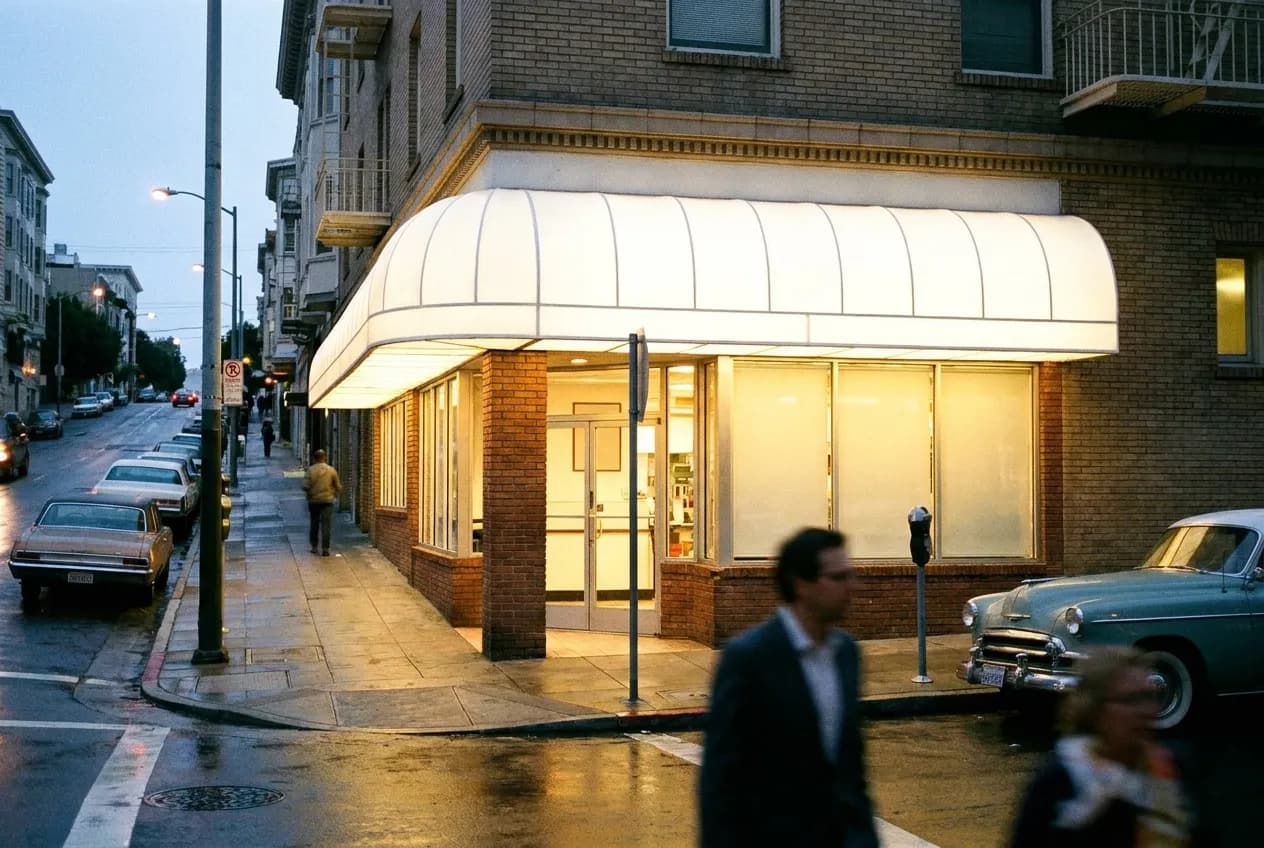 A lit restaurant awning on a San Francisco street at early evening