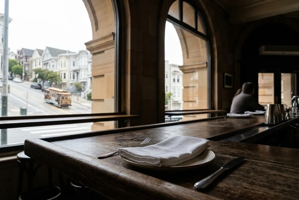 A single place setting at a bar rail with a folded napkin