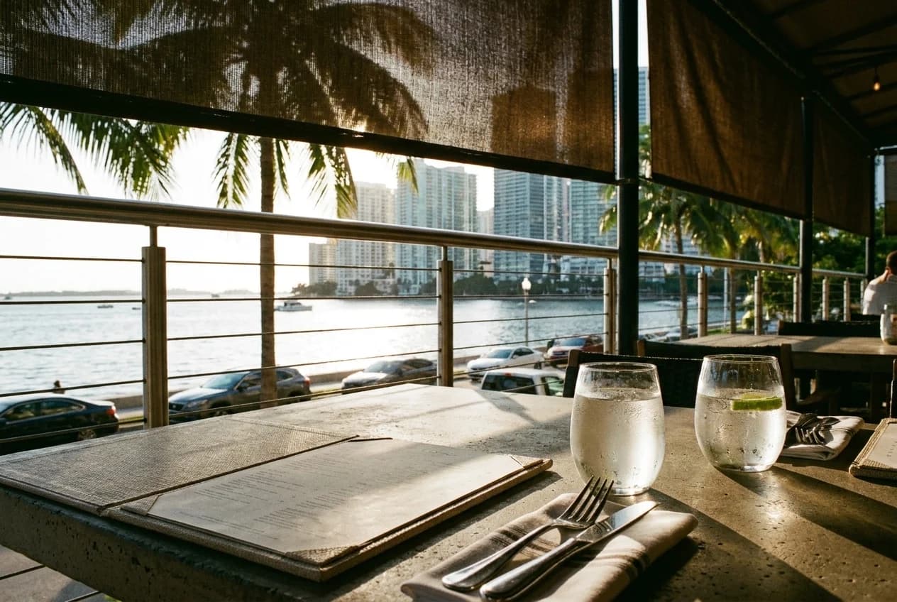 Outdoor restaurant table with bay view on Brickell Key waterfront terrace in Miami