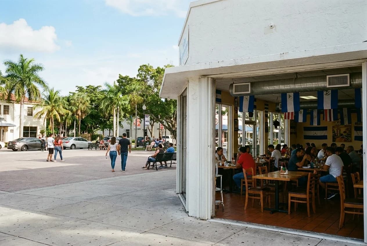 Dining room with tables and Central American flags at restaurant in Little Havana