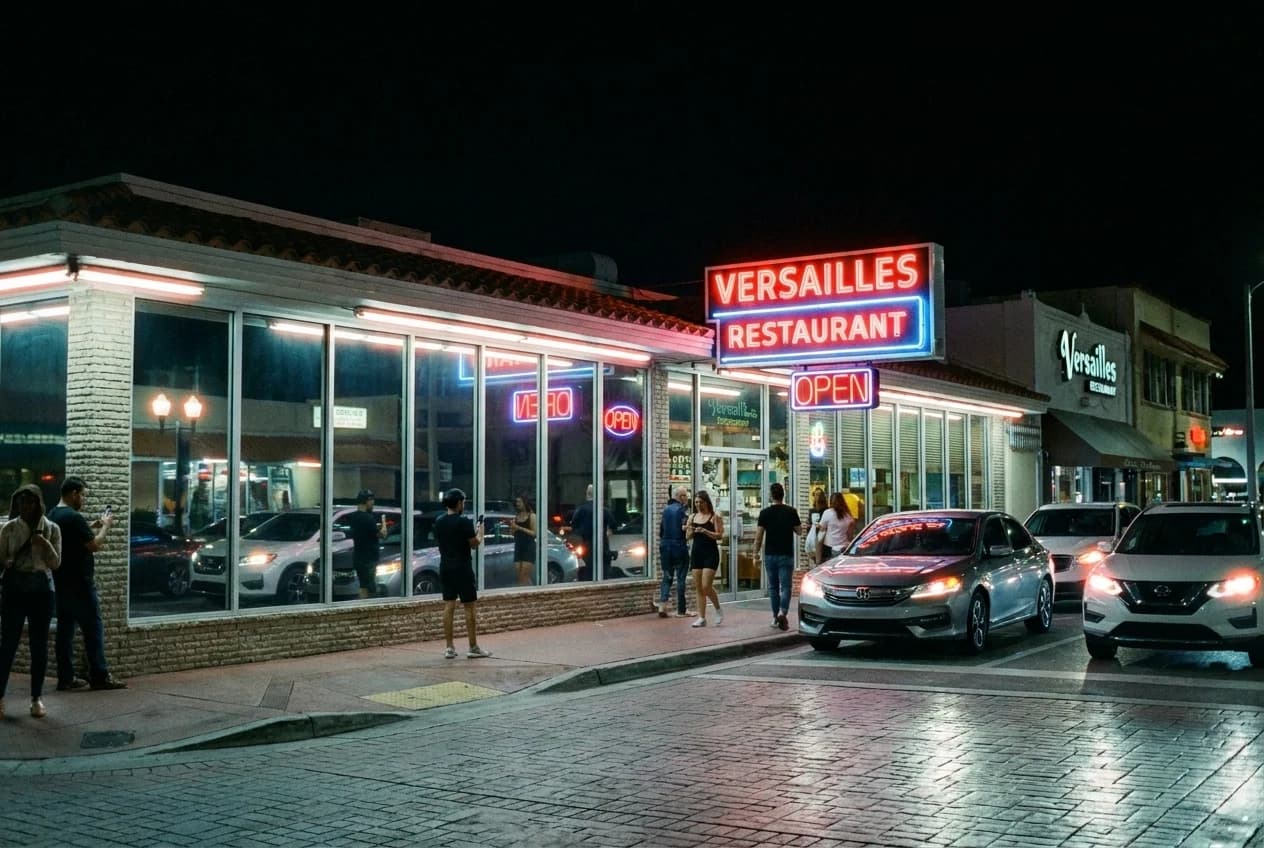 Versailles Restaurant exterior on Calle Ocho at night with mirrored windows and neon lighting