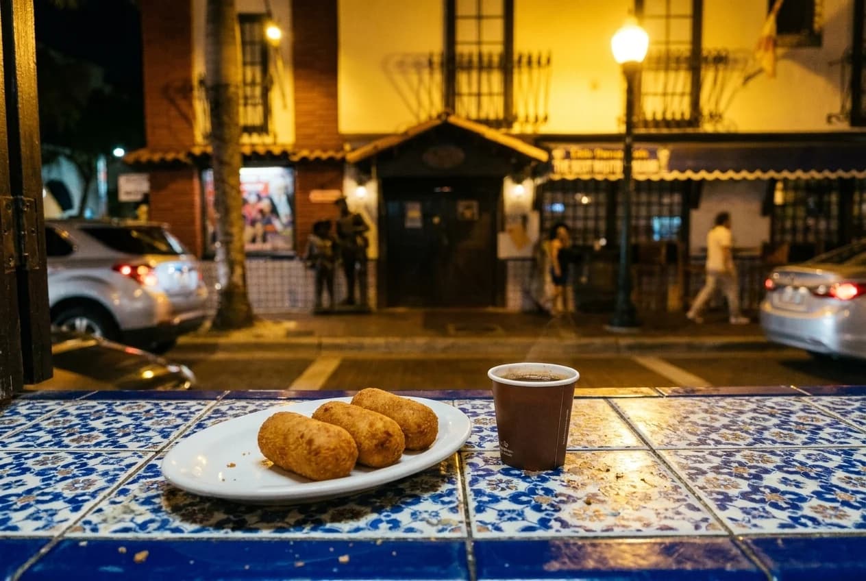 Ham croquetas and Cuban coffee on a blue-tiled ventanita counter at night in Little Havana
