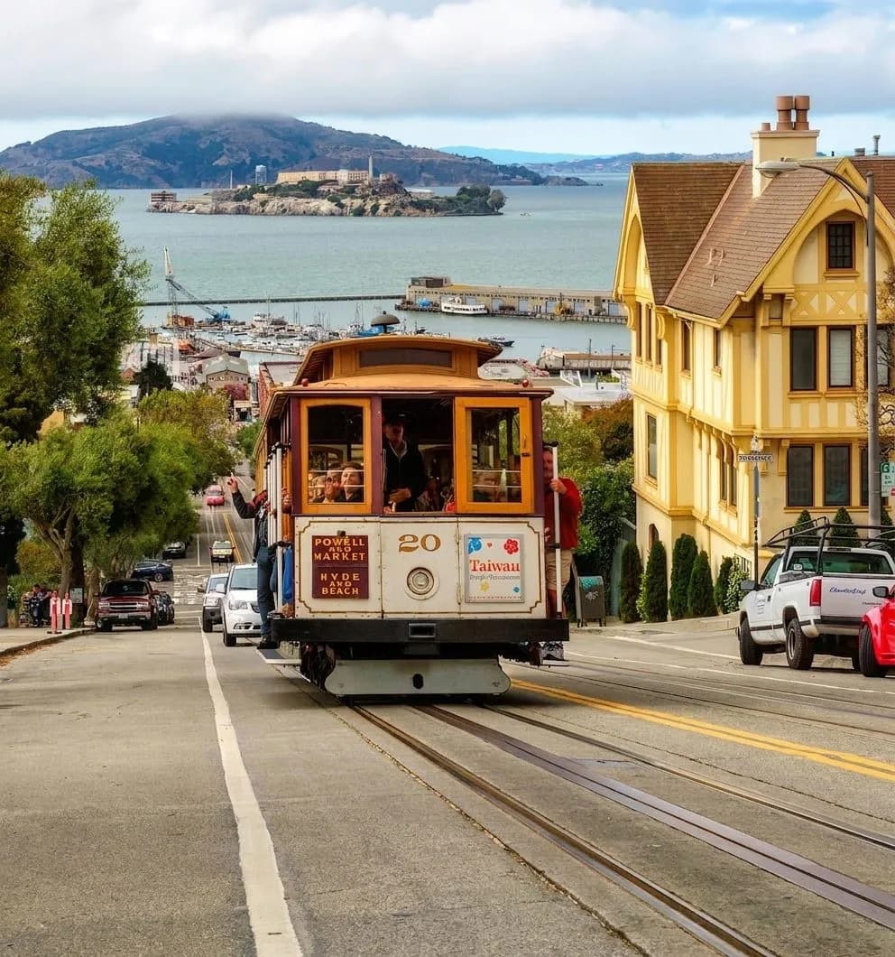Powell-Hyde cable car climbing a steep San Francisco street with bay air and historic storefronts