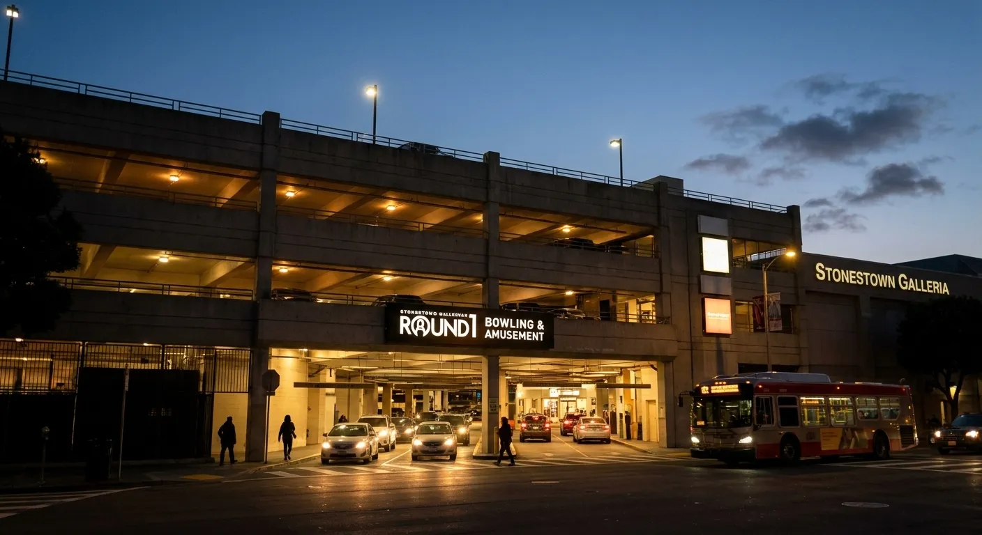 Evening view of Stonestown Galleria parking structure entrance with cars and mall signage visible