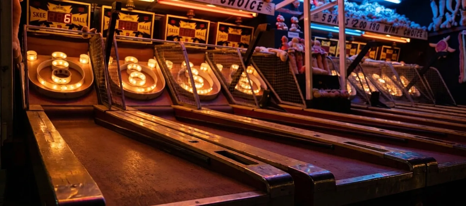 Official Skee-Ball tournament lanes with scoring lights and wooden ramps at Thriller Social Club