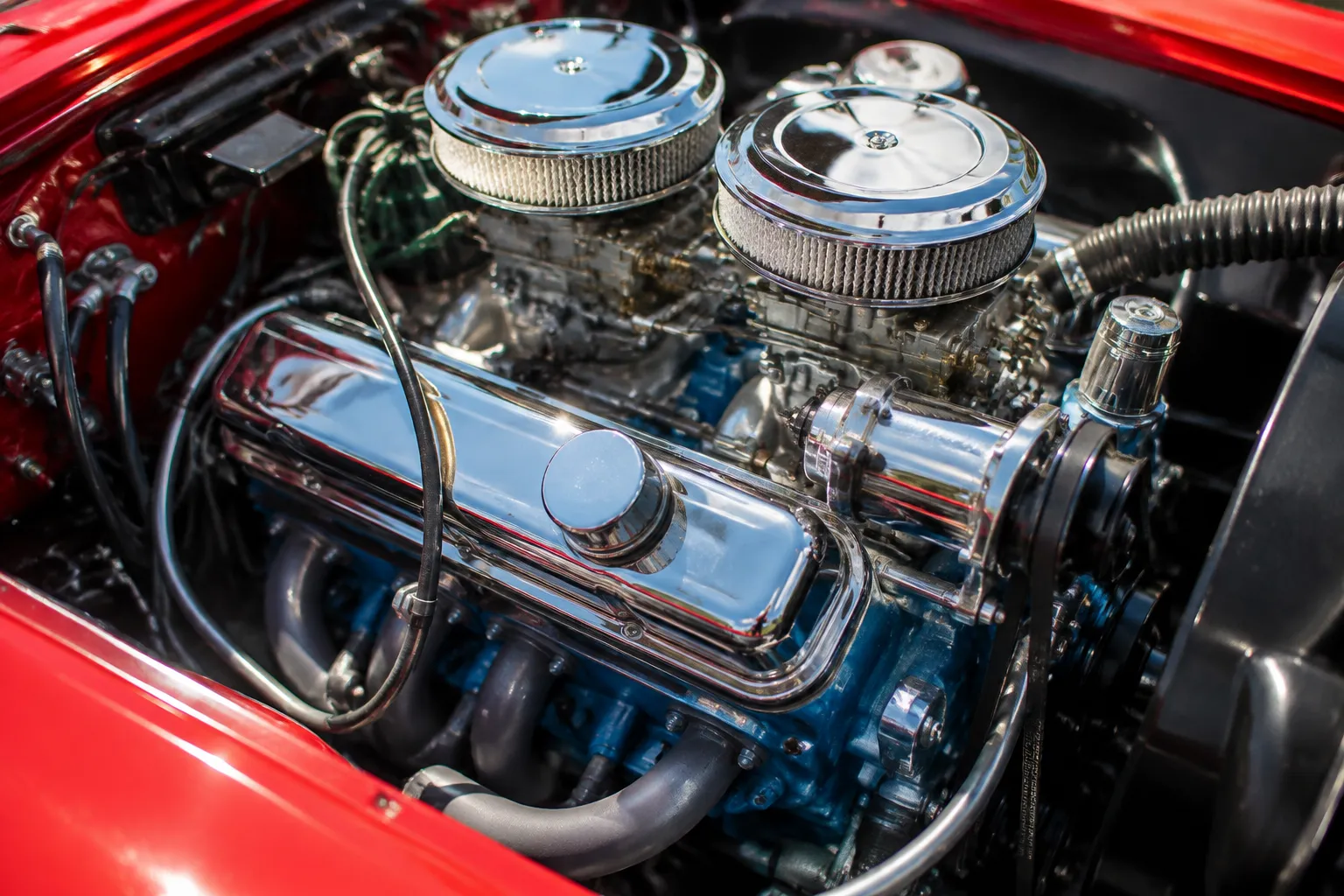 Close-up of polished chrome engine components in a classic car at a San Francisco car show