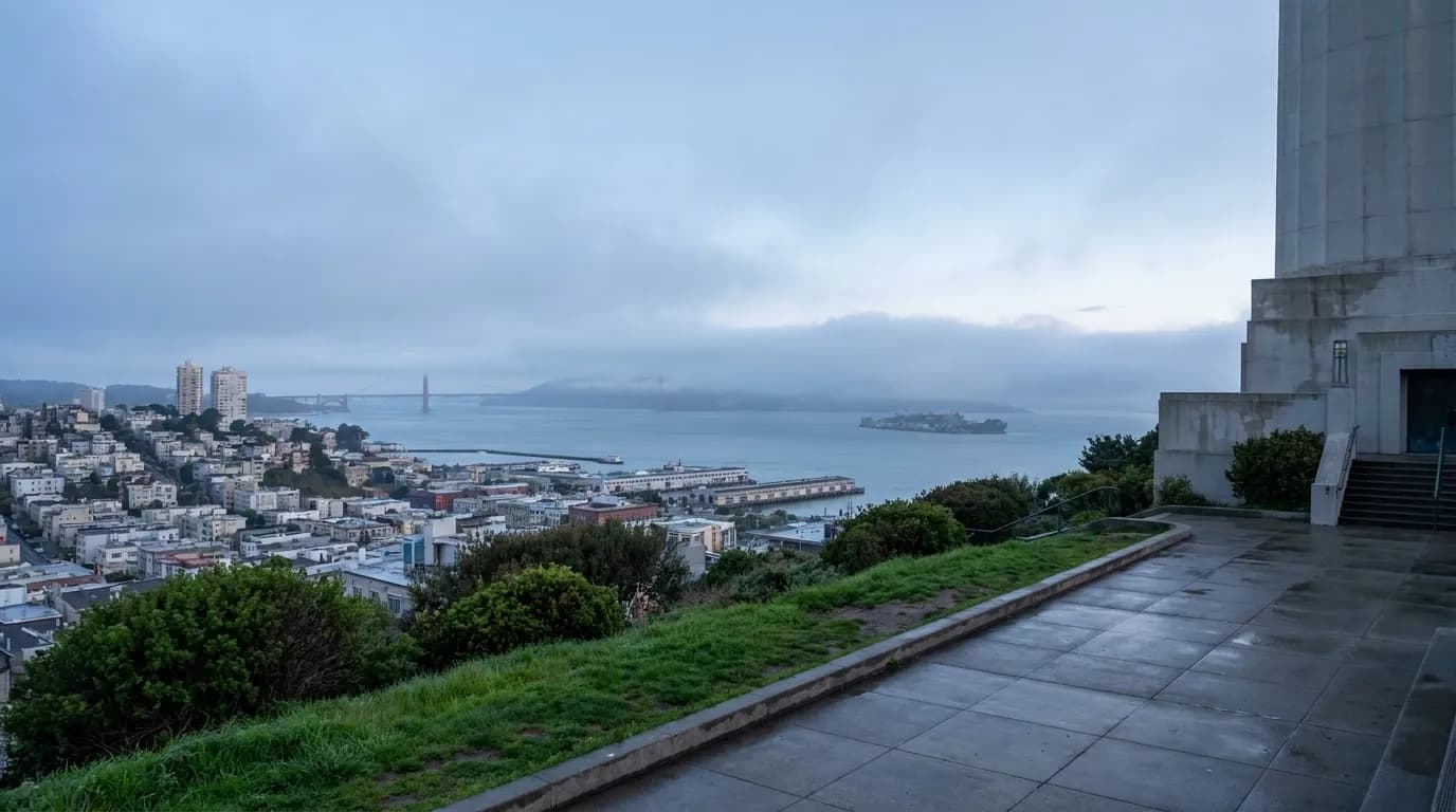 Morning view from Coit Tower across San Francisco Bay with fog rolling over the water and Alcatraz in the distance