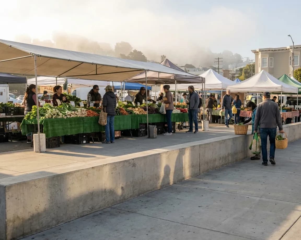 Early morning shoppers browsing produce stalls at Alemany Farmers Market in Bernal Heights with vendor tents and fresh fruits displayed