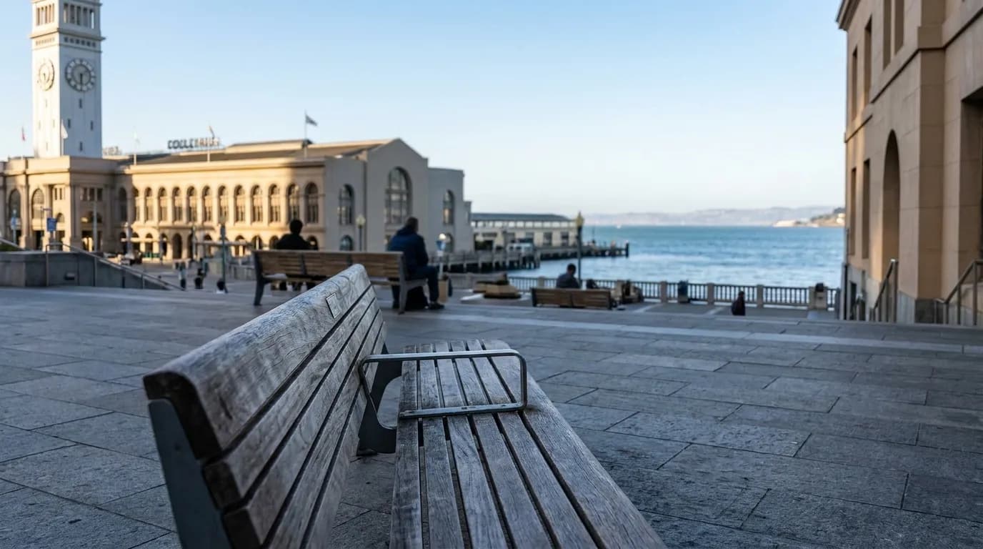 Public benches facing the bay at the Ferry Building plaza in late afternoon light