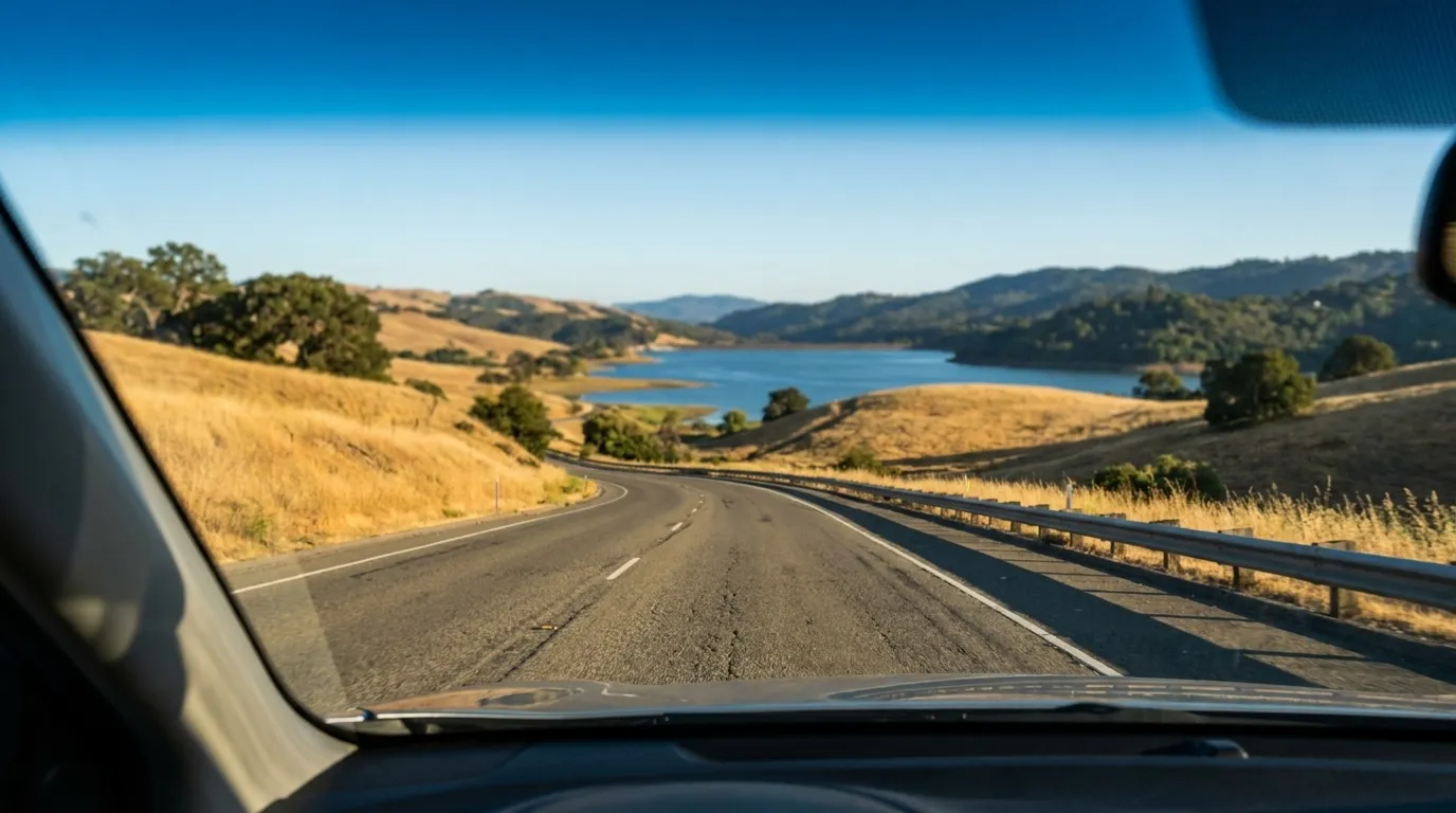 View through car windshield driving south on Highway 280 past Crystal Springs Reservoir