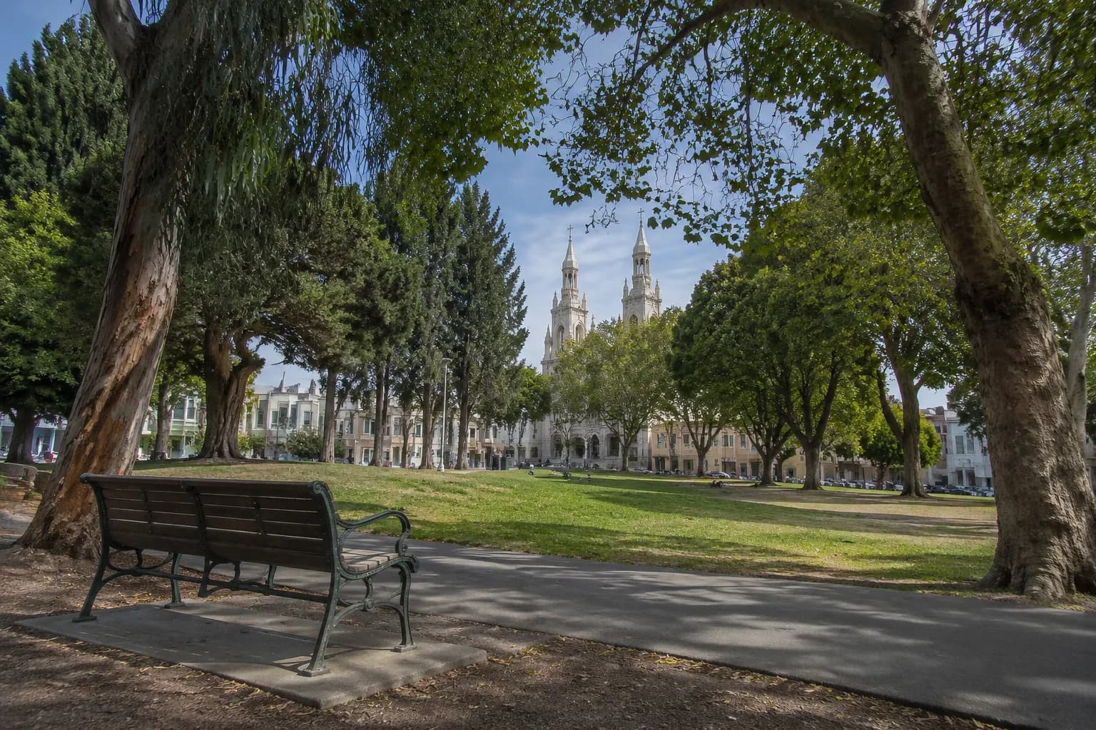 Washington Square Park bench area in North Beach with church in background, afternoon light