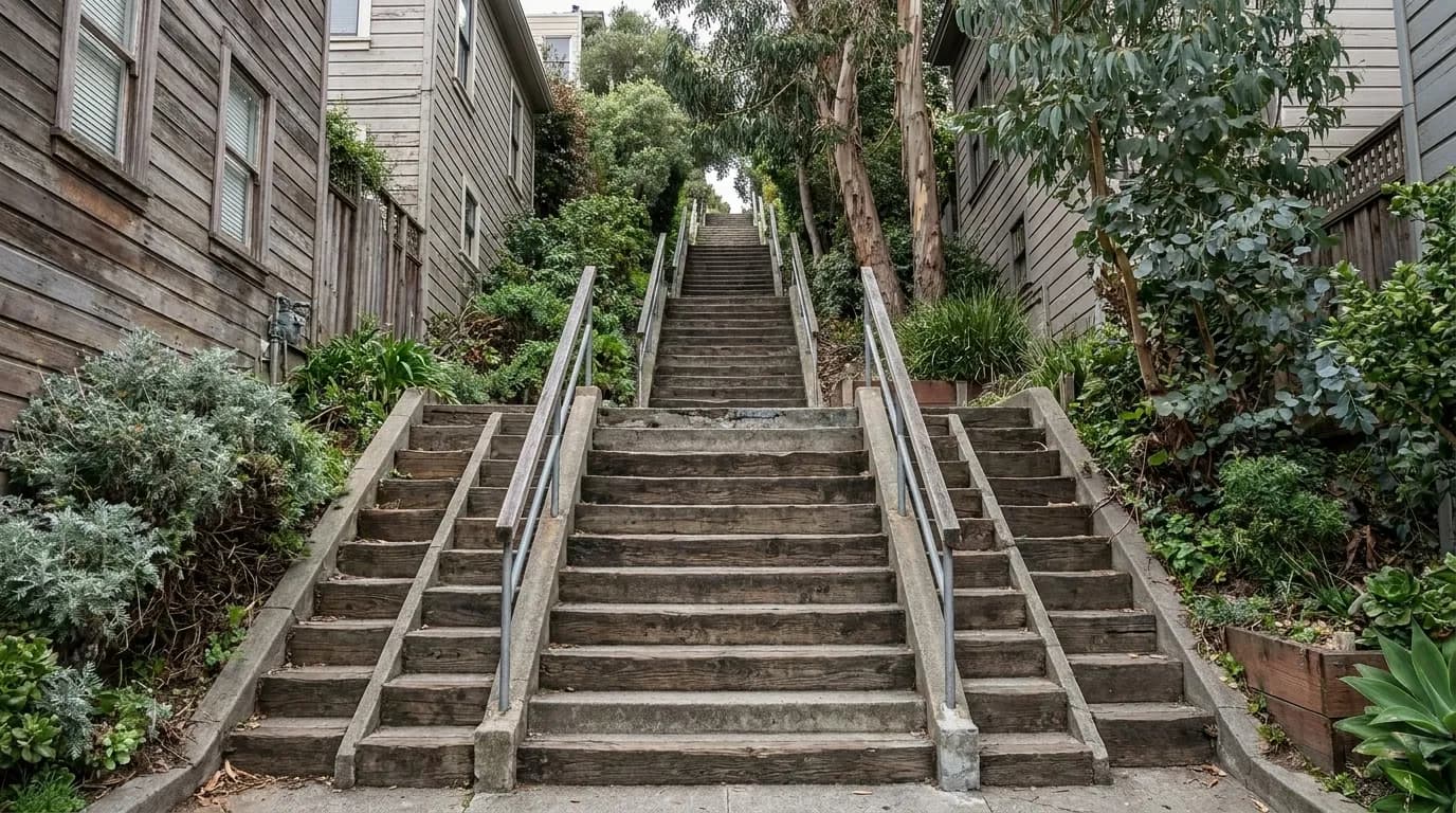 Filbert Steps climbing Telegraph Hill, flanked by wooden cottages and garden foliage under dappled eucalyptus shade