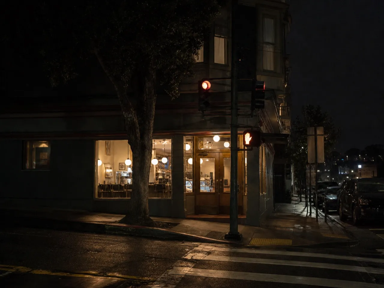 Corner cafe in San Francisco lit from inside before dawn