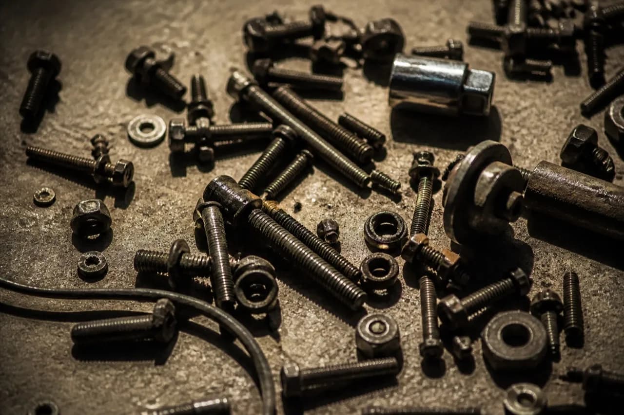 Bolts and hand tools scattered on a workshop floor