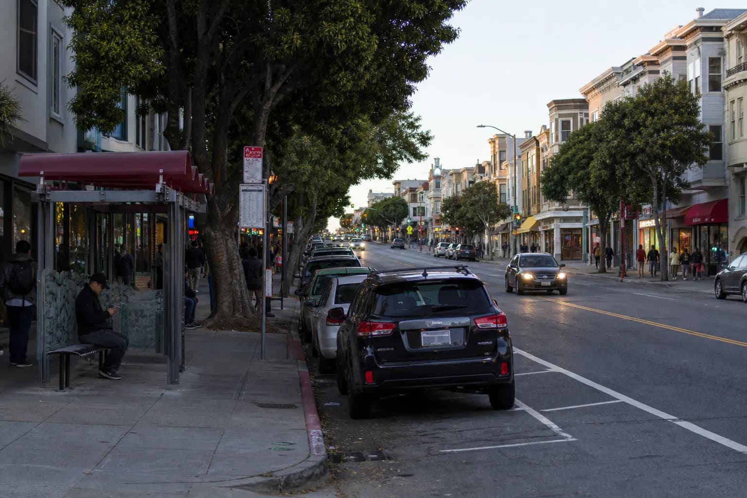 West Portal neighborhood street with storefronts, transit access, and curb parking