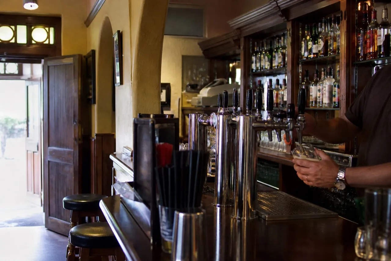 Old pub bar with taps and mirrored back shelf