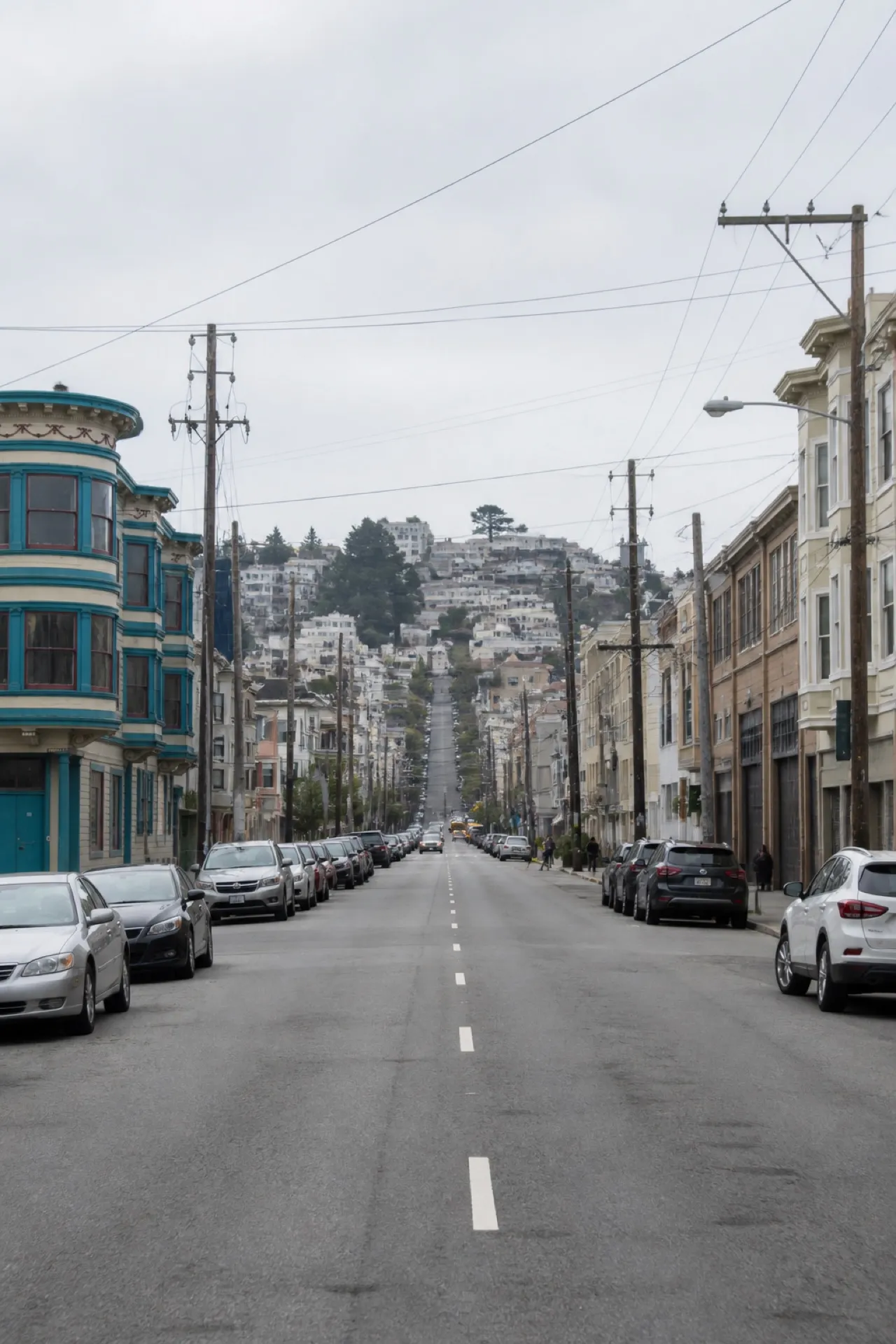 San Francisco commercial street rising toward a hill under flat coastal light