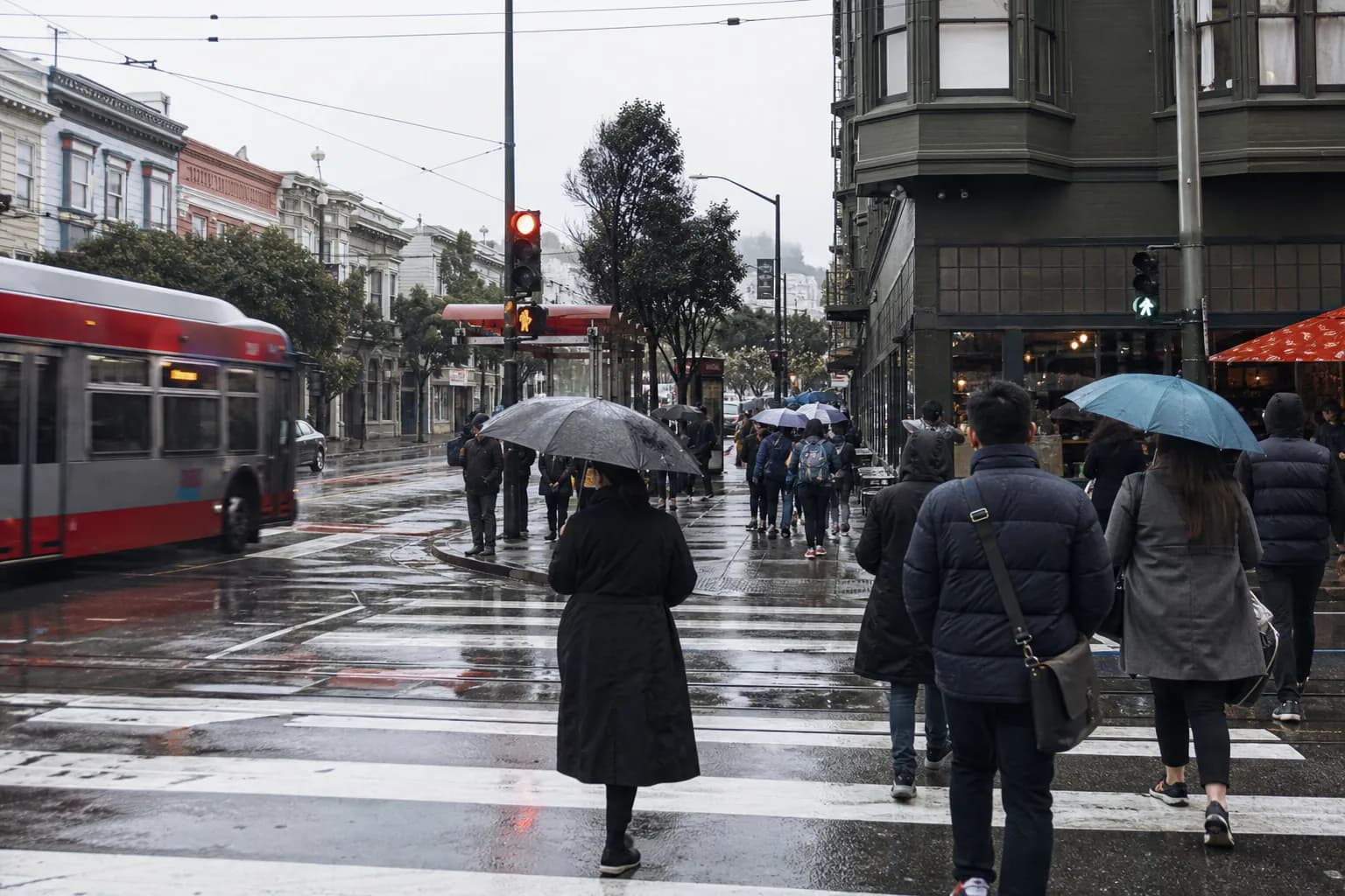 Muni stop and umbrellas near Hayes Valley on a rainy afternoon