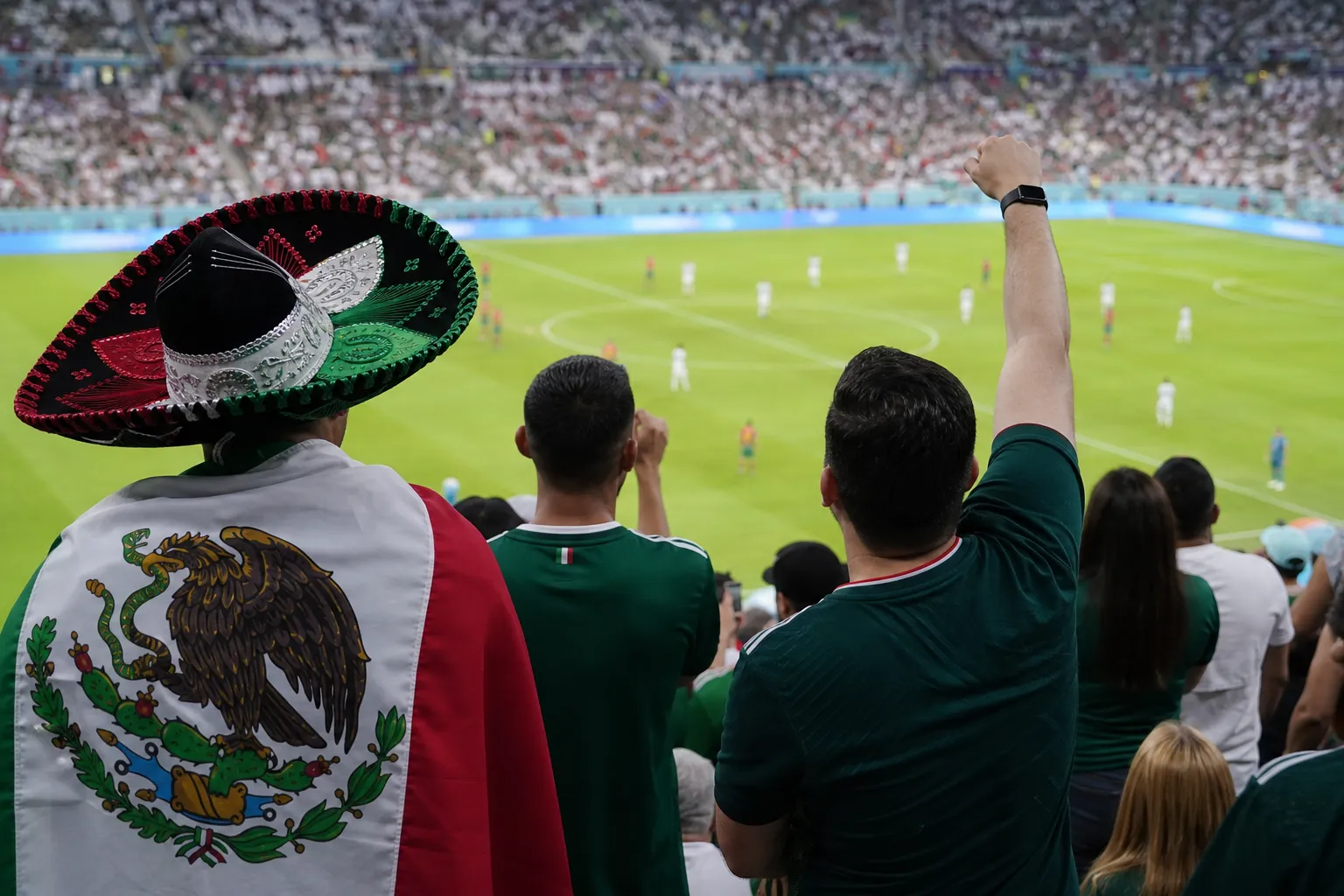 Supporters reviewing striker chances and lineup notes during a World Cup match
