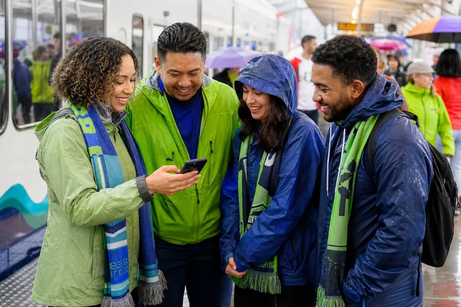 Seattle fans using light rail and rain layers before a World Cup match
