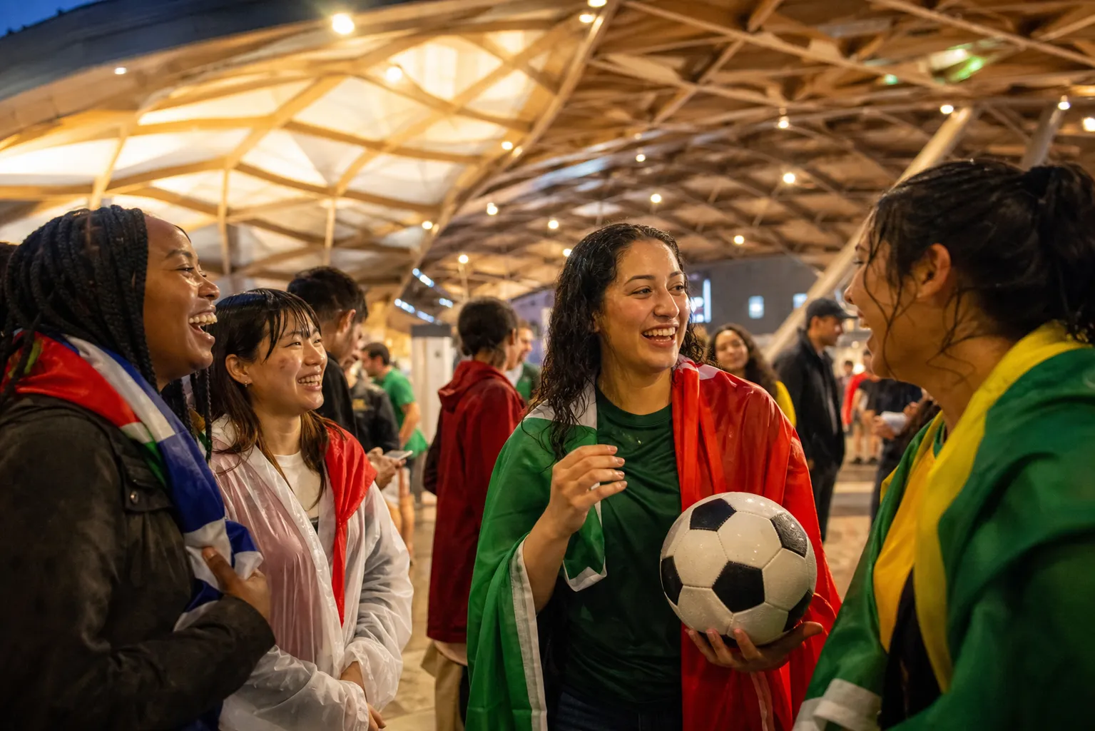 Seattle fans waiting under cover after a rainy World Cup stadium exit