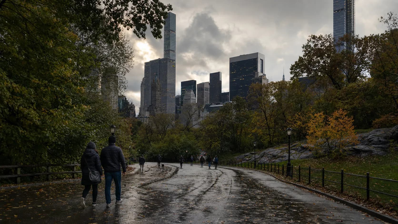 A wet Central Park path after a thunderstorm with pedestrians in the distance.