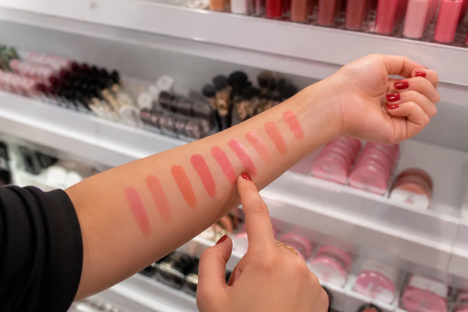 Swatching cream blushes inside a makeup store
