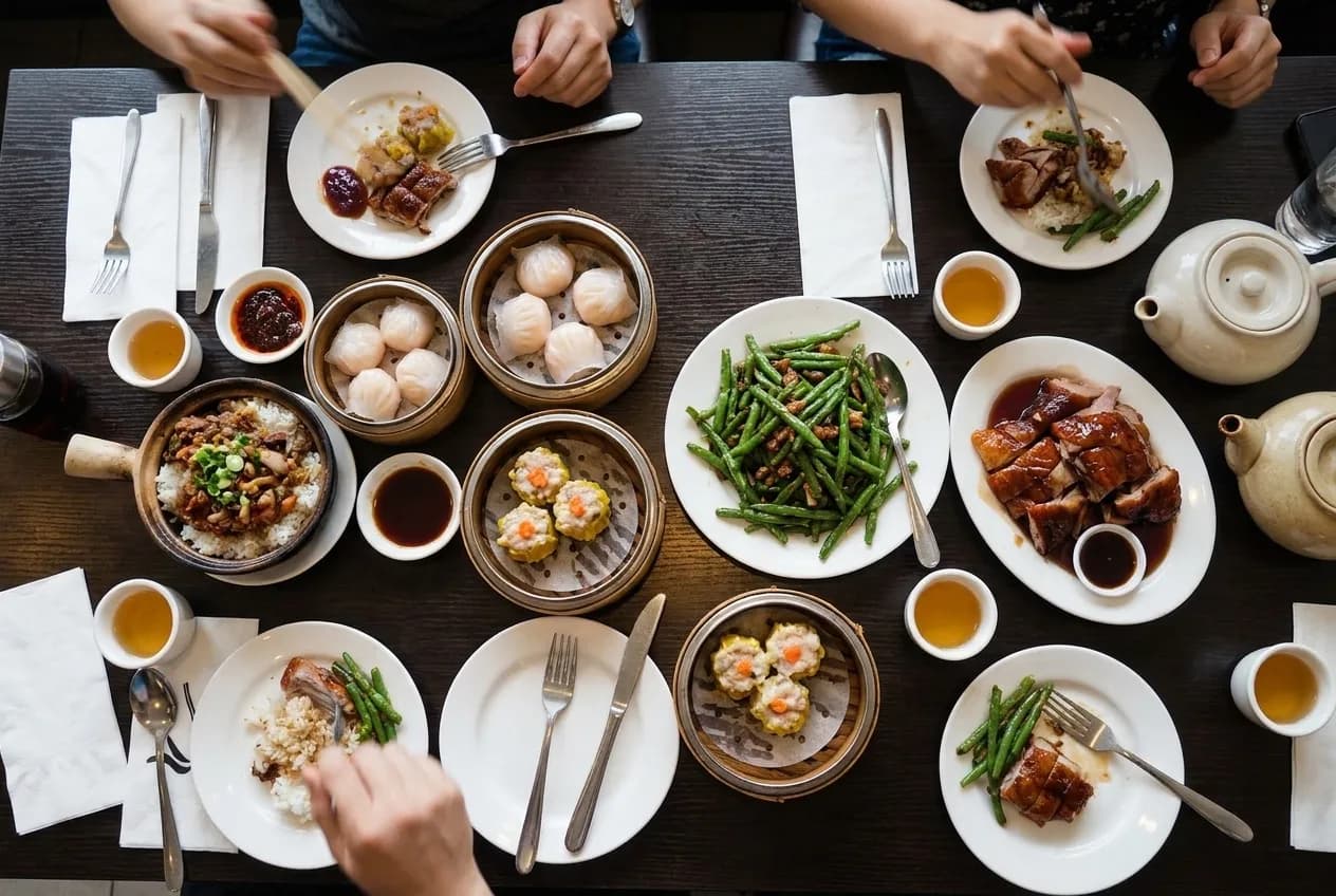 Shared plates crowded onto a small table, seen from directly above