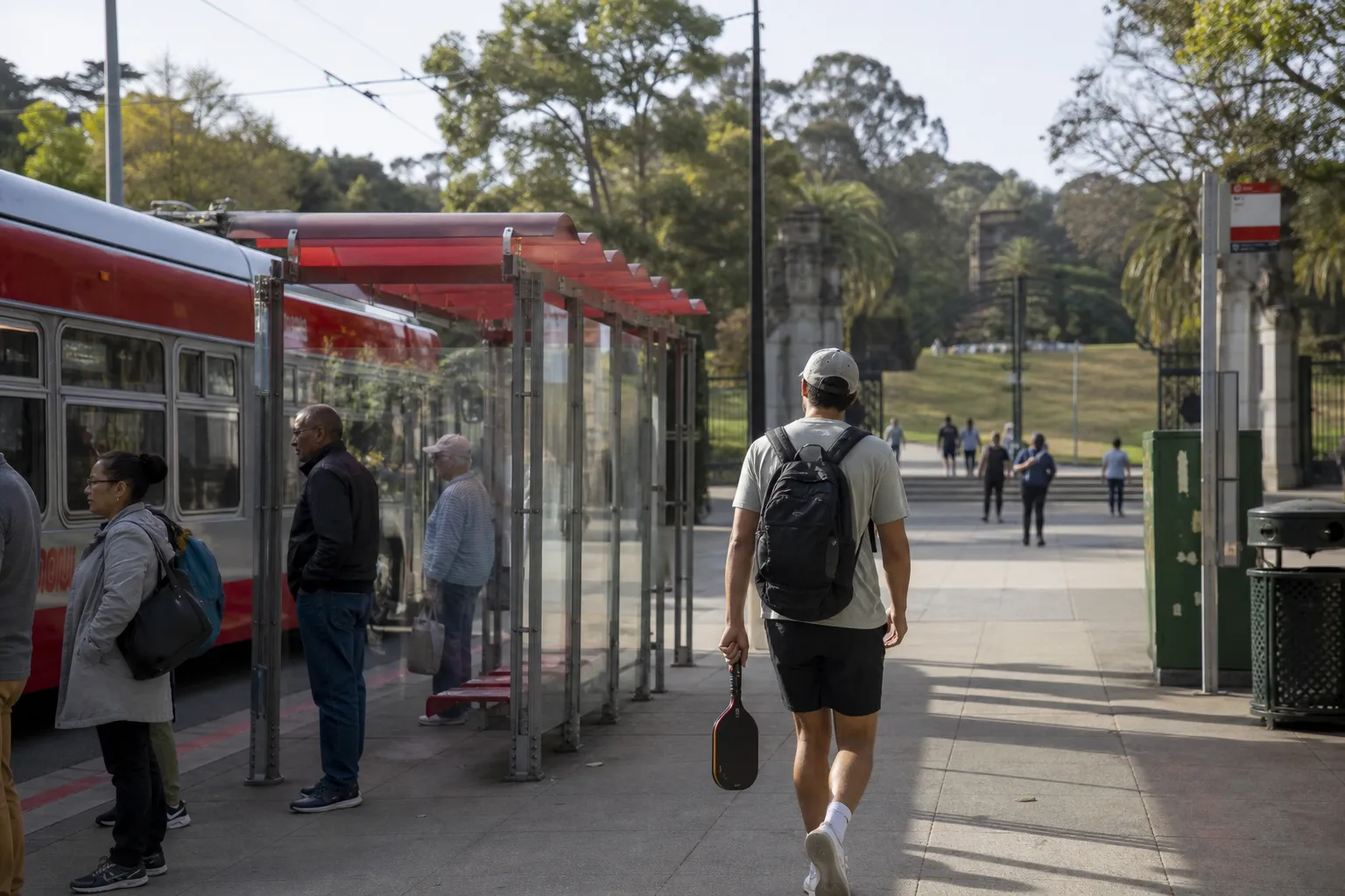 A San Francisco Muni stop near a park where people are heading to play pickleball