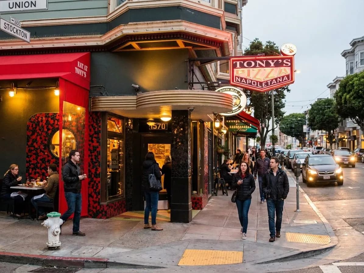 North Beach pizza restaurant exterior on a lively San Francisco street at dusk