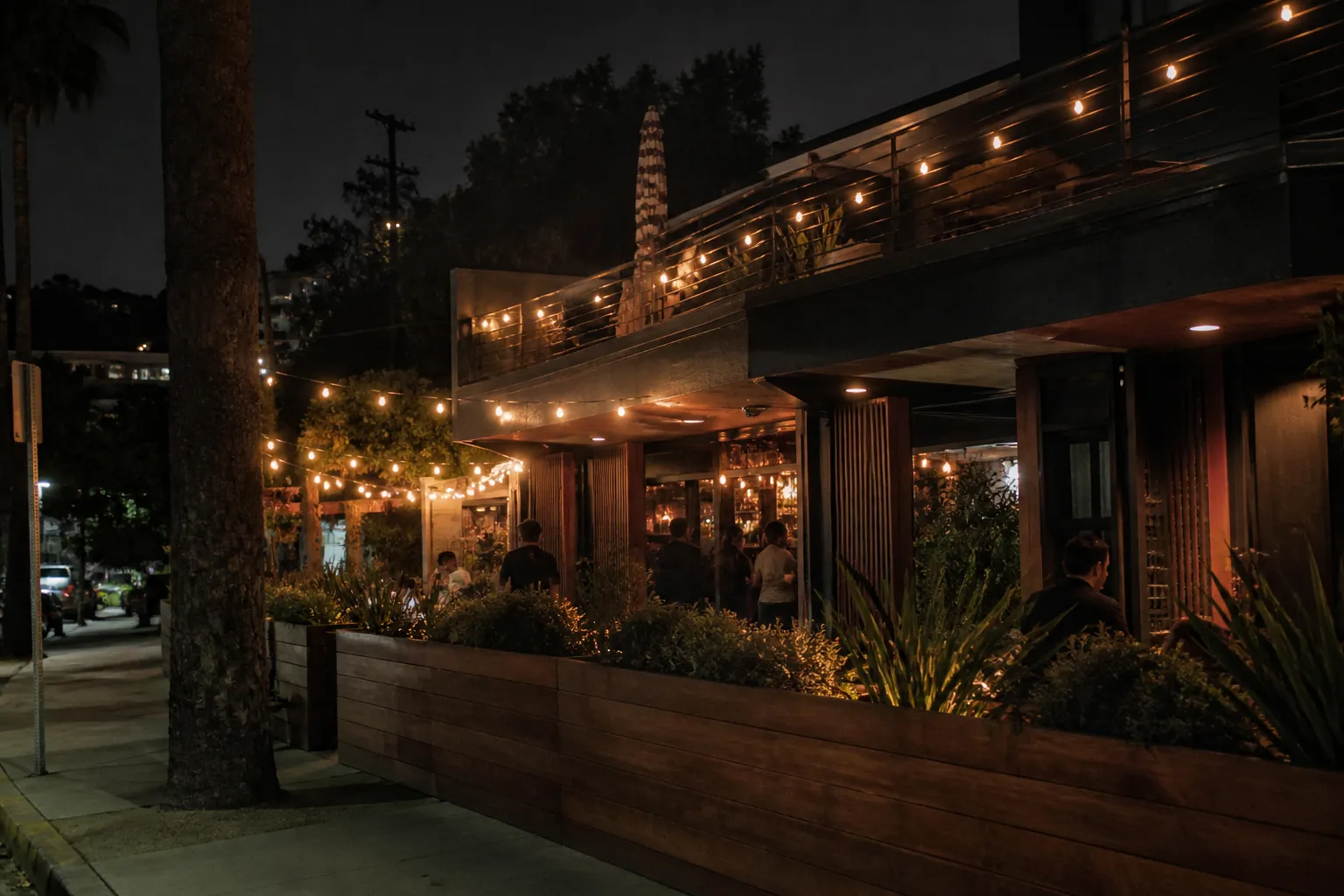 Silver Lake patio bar exterior at dusk with warm lights and DJ glow