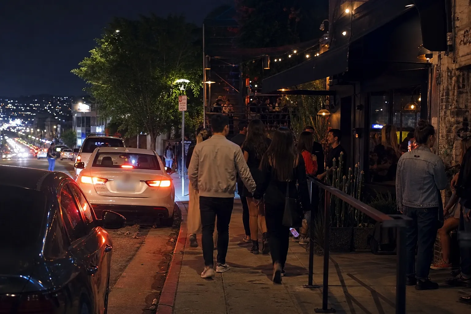 Open-air Silver Lake bar patio with patrons talking and DJ in the background