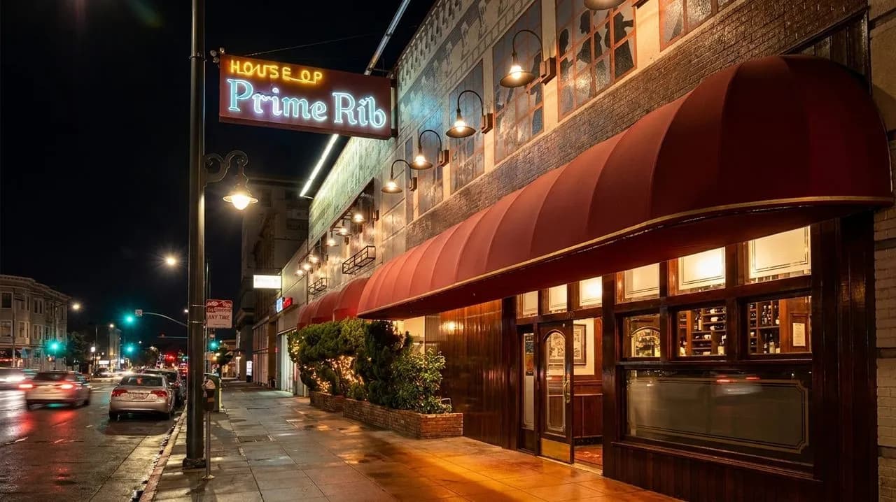 Glowing steakhouse entrance on a Van Ness night street