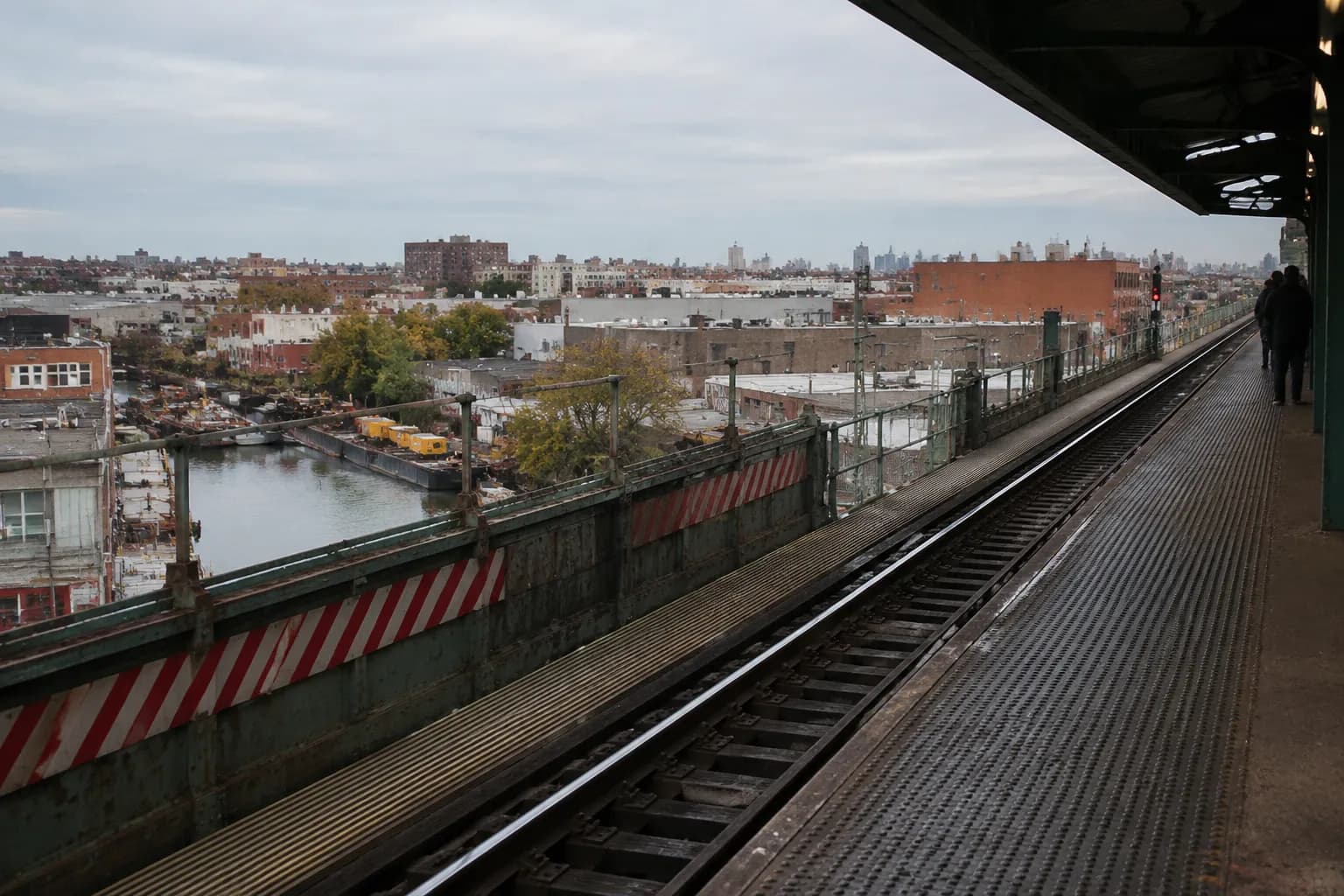 Elevated Smith-9th Street subway platform overlooking Gowanus industrial buildings and rooftops in Brooklyn