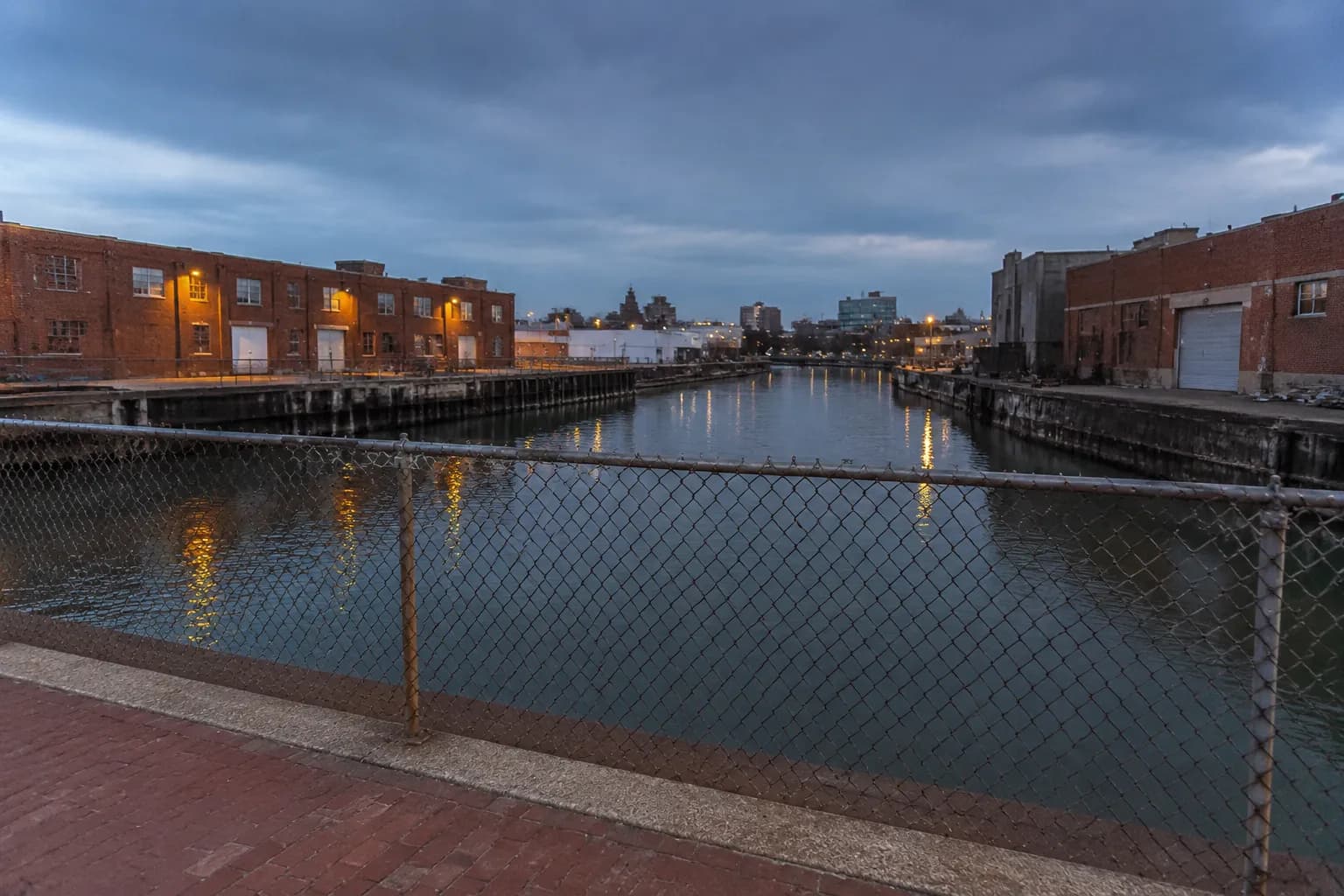Gowanus Canal waterfront with industrial brick warehouses at dusk in Brooklyn