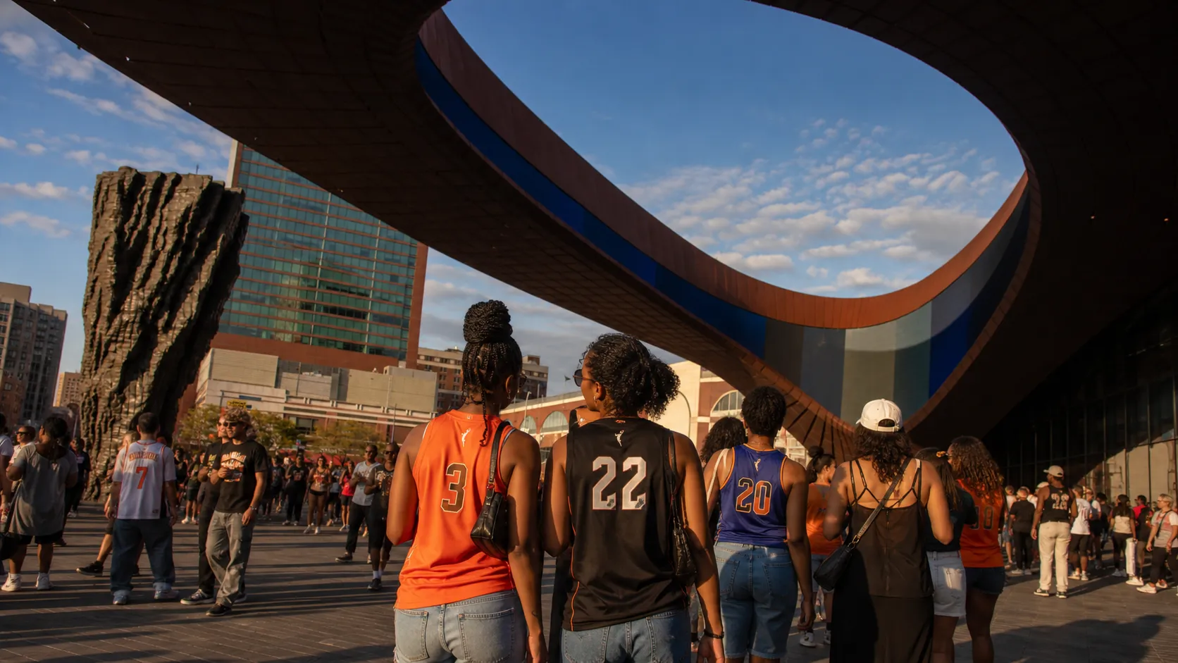 WNBA fans walking toward Barclays Center in Brooklyn before a summer game.