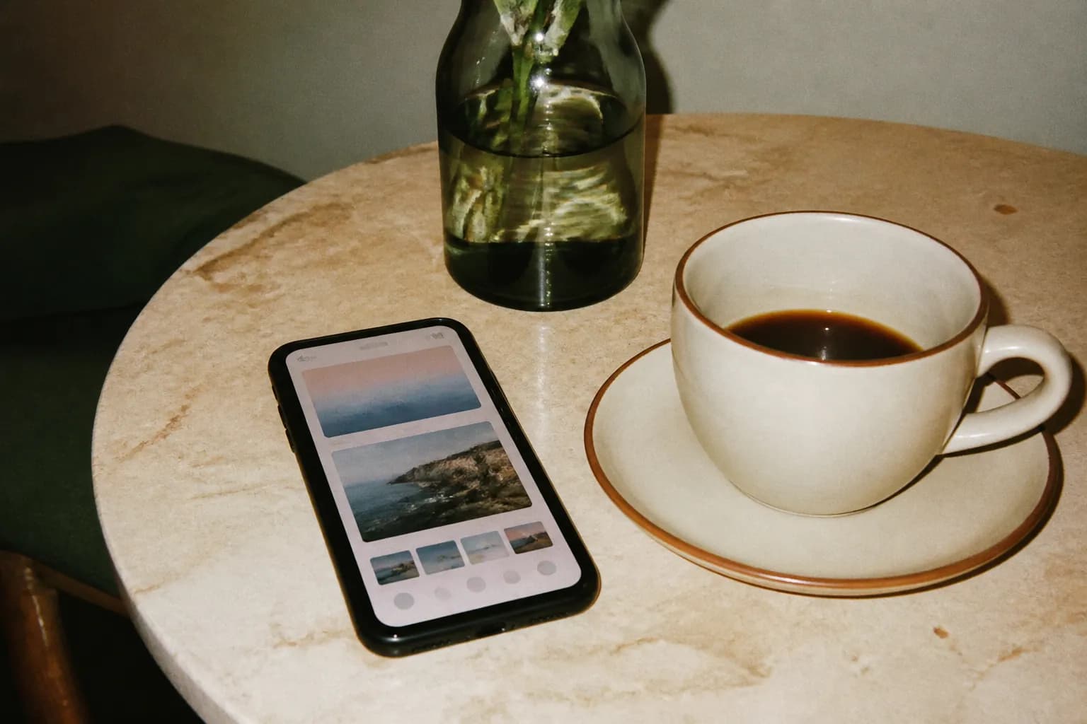 A phone app open beside a coffee cup on a wooden table