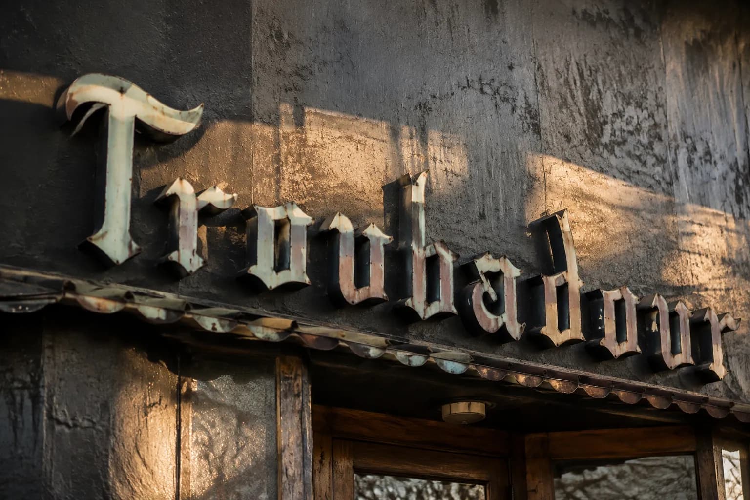Close-up of weathered Troubadour entrance sign in West Hollywood