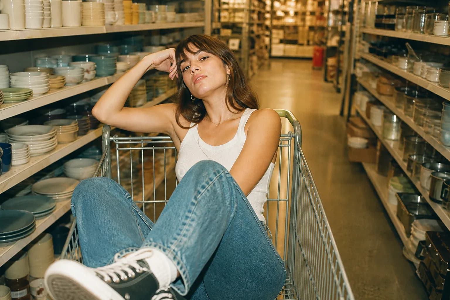 A shopping cart parked in a wide, clean, well-lit retail aisle