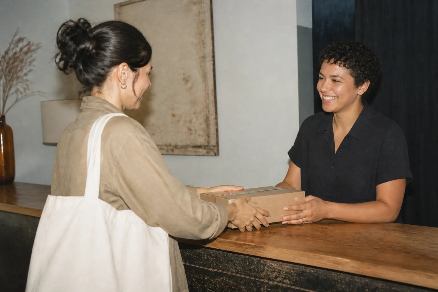 A guest service counter with a small return package resting on top