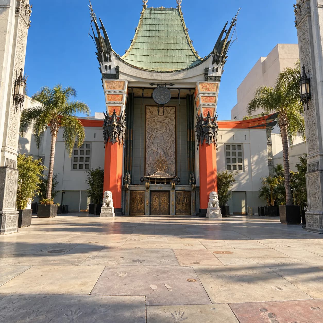 Ornate pagoda-style theatre facade with a tall curved roofline, red columns flanking the entrance and carved stone detailing