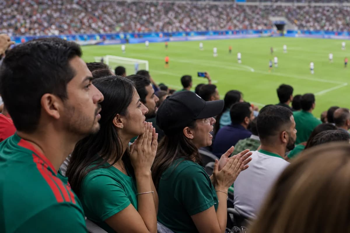 Fans checking Telemundo World Cup broadcast details before entering a viewing venue