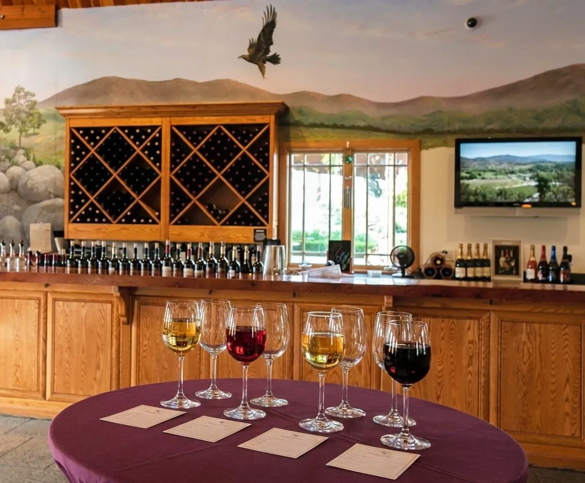 Wine tasting counter with flights and a calm winery interior in Temecula
