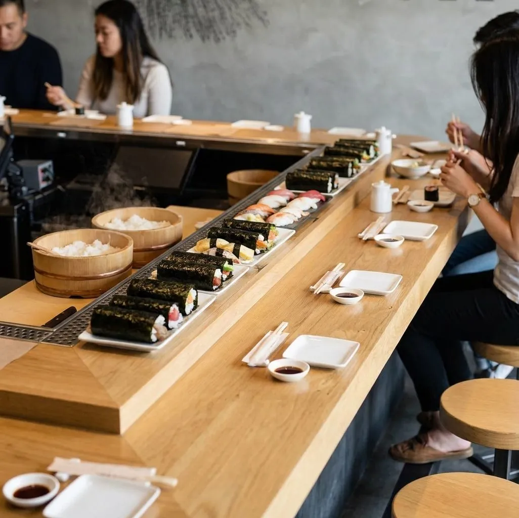 Hand rolls and nigiri arranged on a wooden counter in Los Angeles