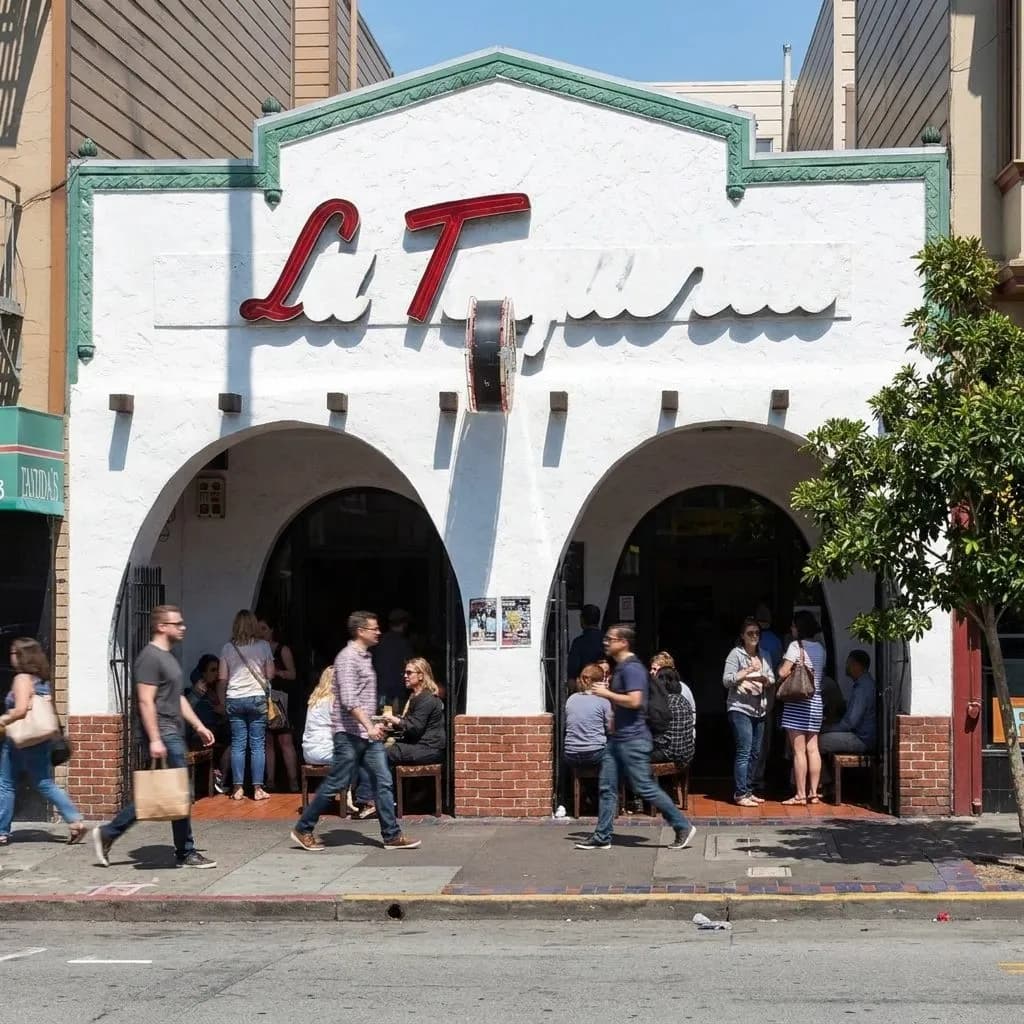 Mission District burrito storefronts and foot traffic on a busy San Francisco street