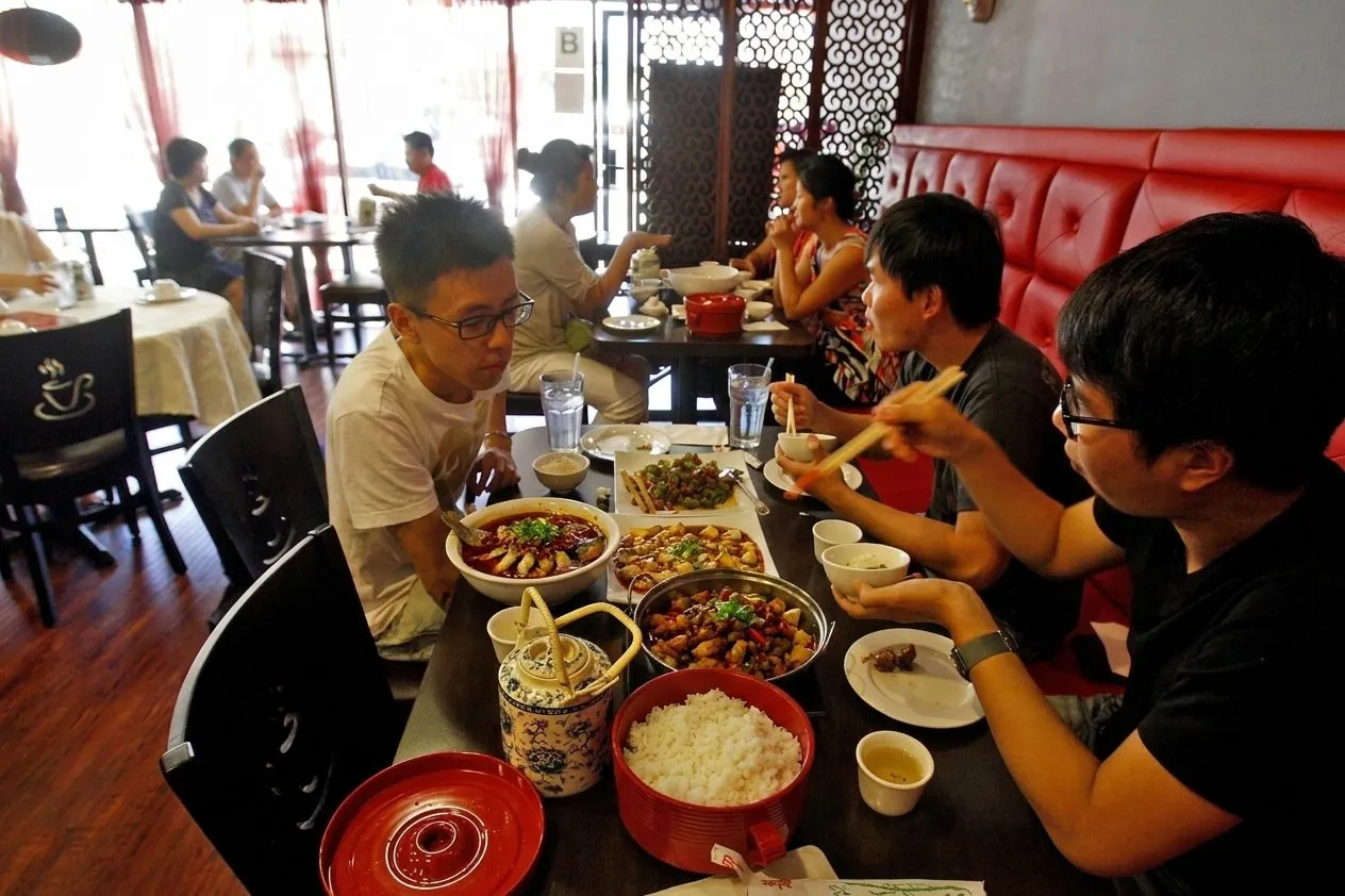 Chengdu Taste dining room with shared Sichuan dishes on the table