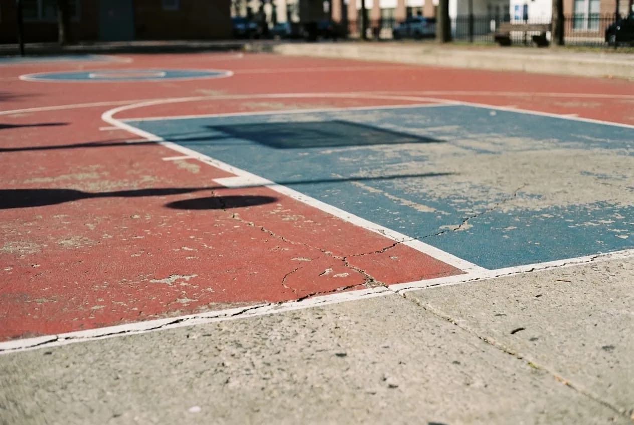 Close-up of painted lines on outdoor basketball court concrete surface