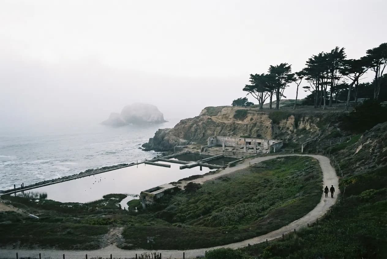 Concrete ruins on the San Francisco coast with fog rolling over the headland