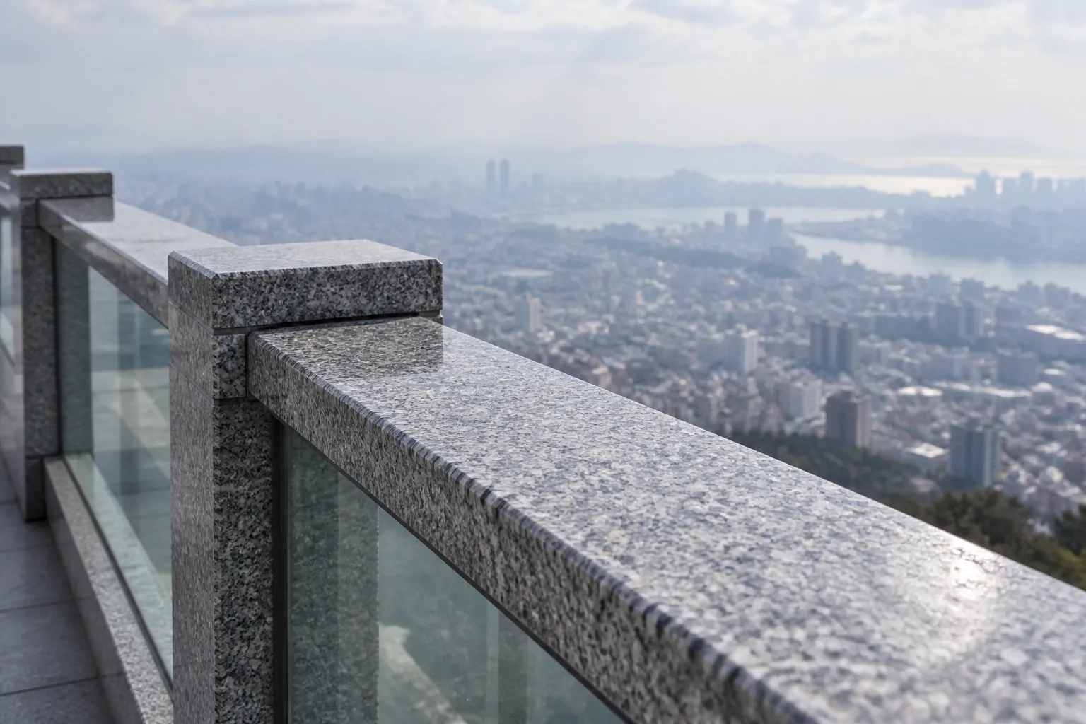 An open-air viewing deck parapet with the city dropping away below
